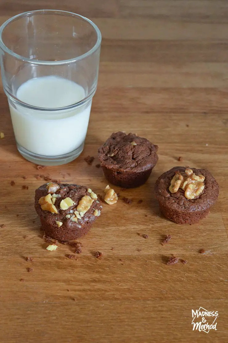 three chocolate walnut brownies with glass of milk