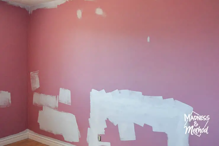 pink painted walls with patched areas