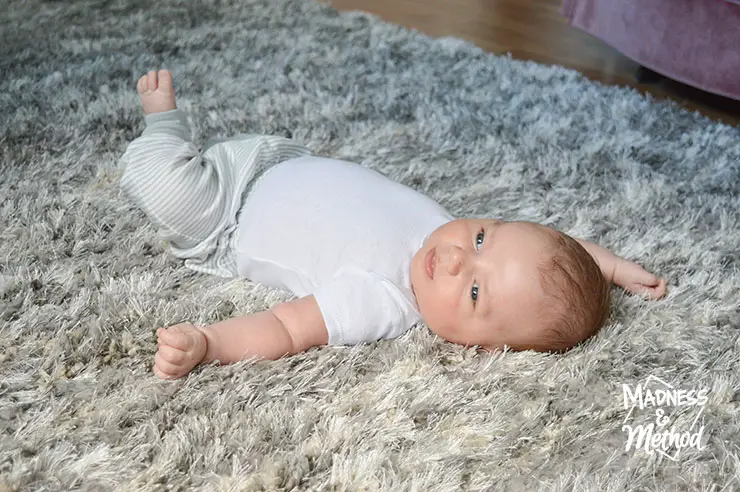 closeup of baby on shag gray rug