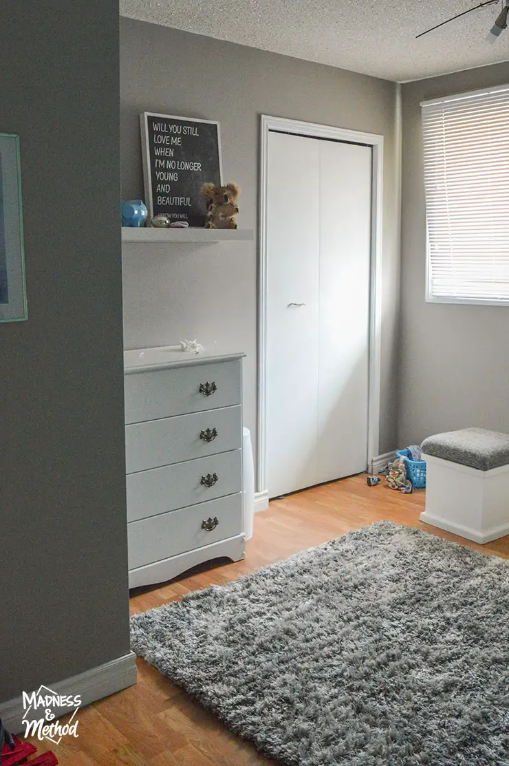 nursery with gray walls white furniture and gray shag rug