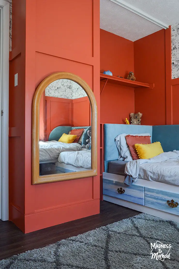 kids bedroom with red orange walls and gray shag rug