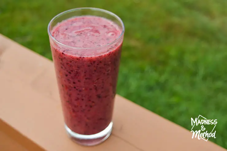 burgundy smoothie in clear glass outside