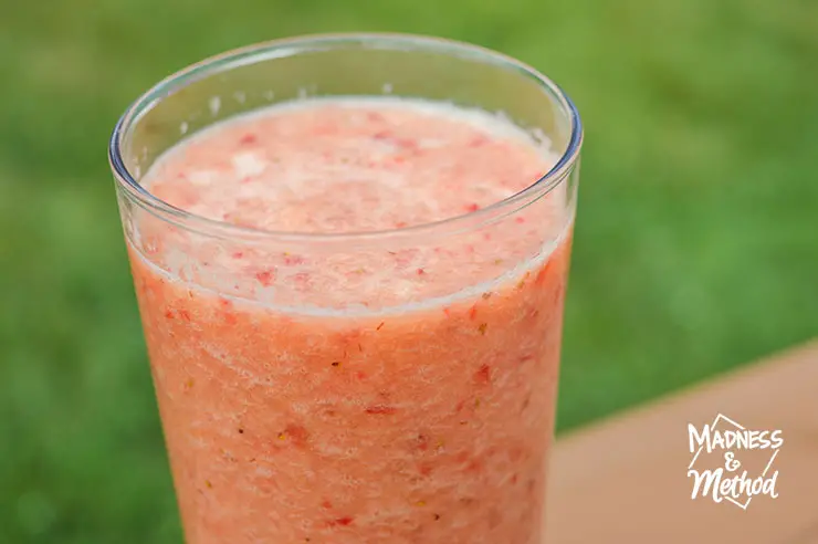 orange pink smoothie with grass background