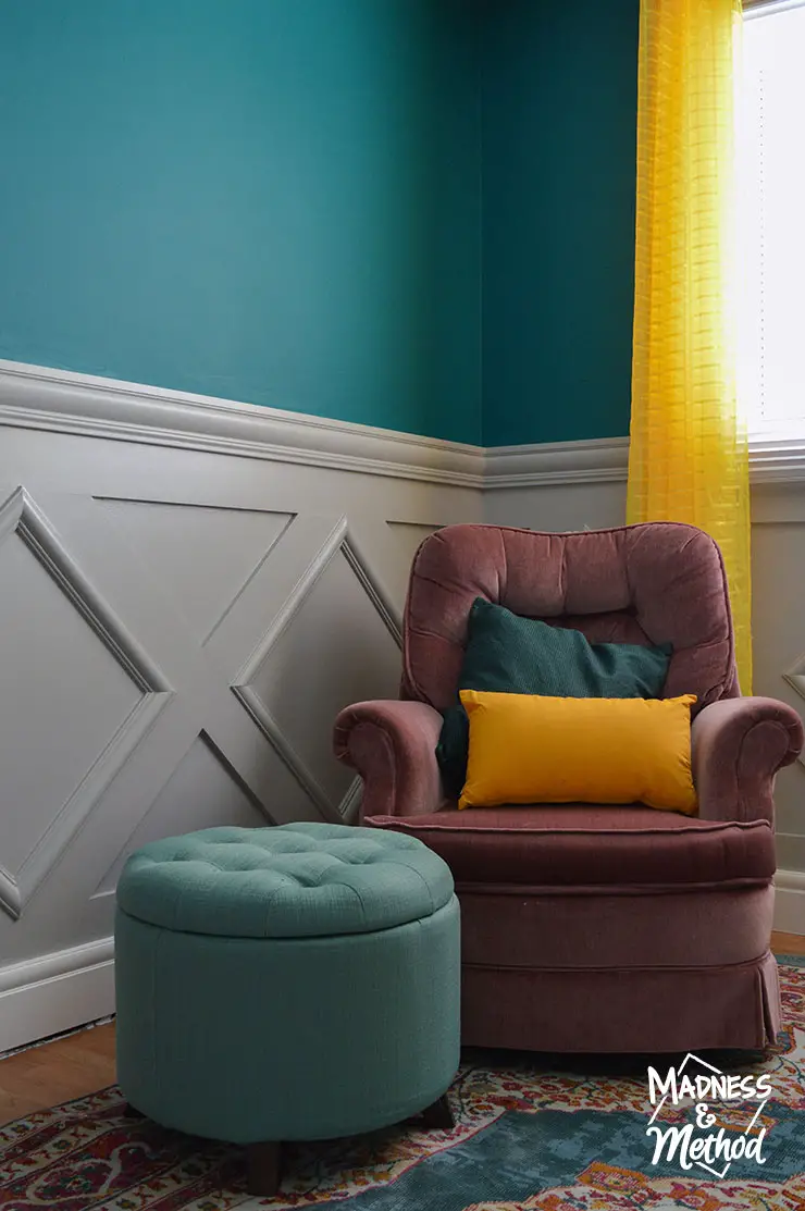 gray wainscoting with pink chair