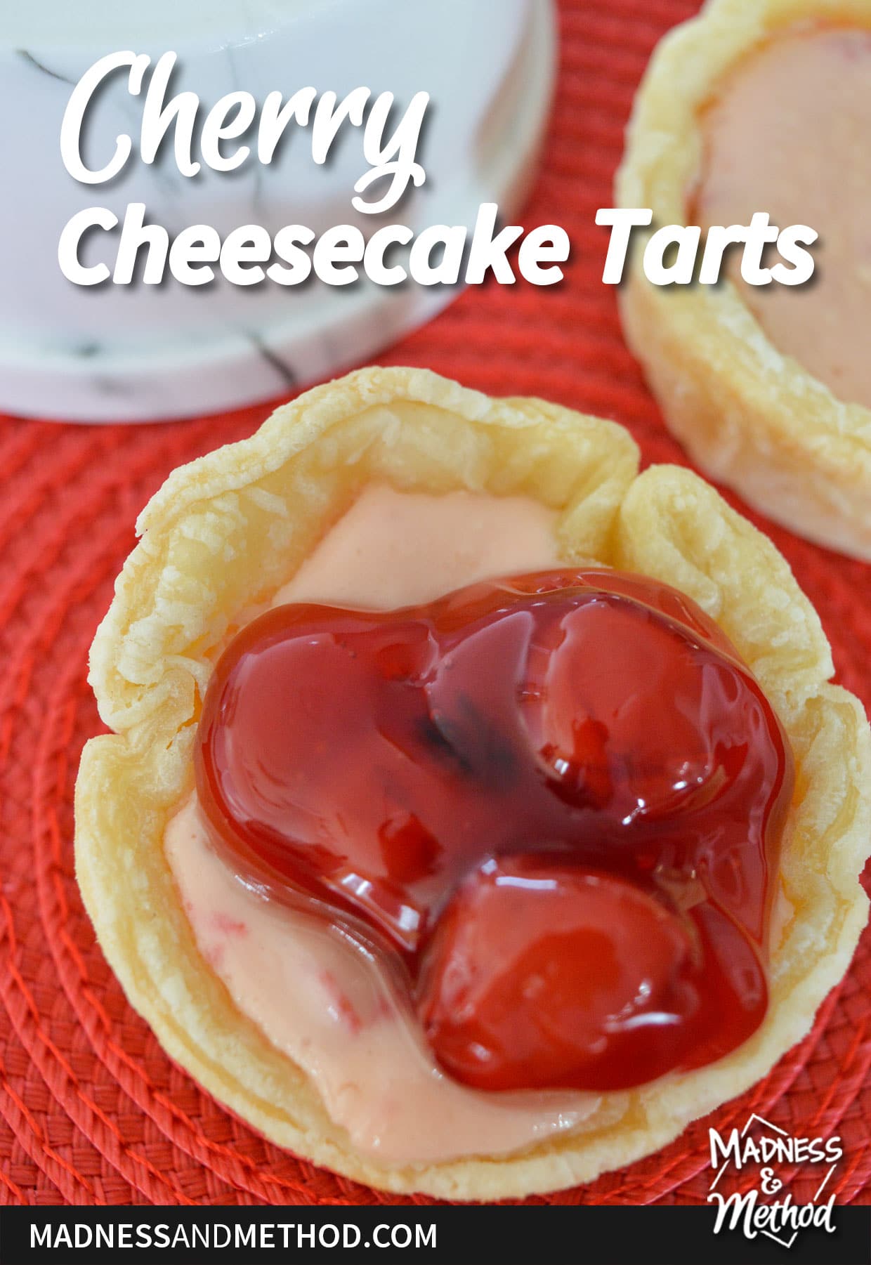 cherry cheesecake tarts text overlay on mini cheesecake with cherry filling