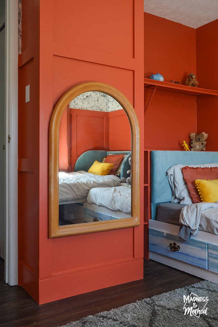 heavy round top mirror on red wall