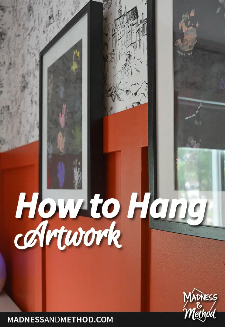 how to hang artwork on closeup of handprints and red board and batten