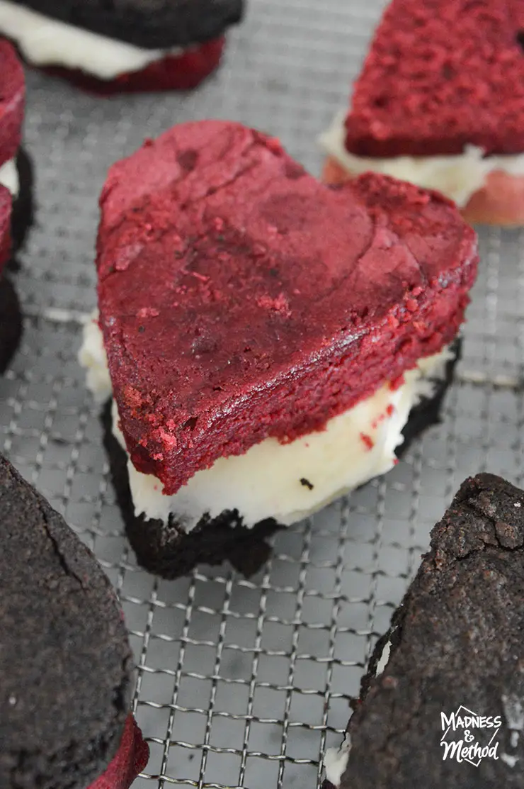red velvet heart shaped brownie with frosting and chocolate brownie base