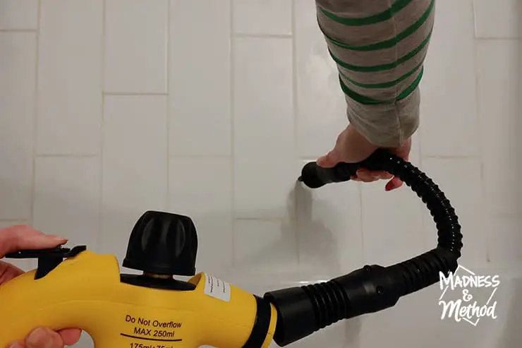 using yellow steam cleaner on white tiles