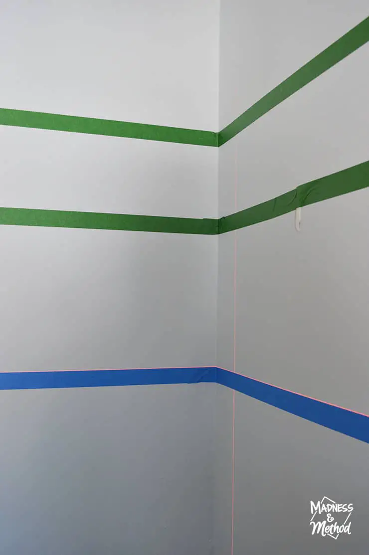painters tape across a corner with laser level