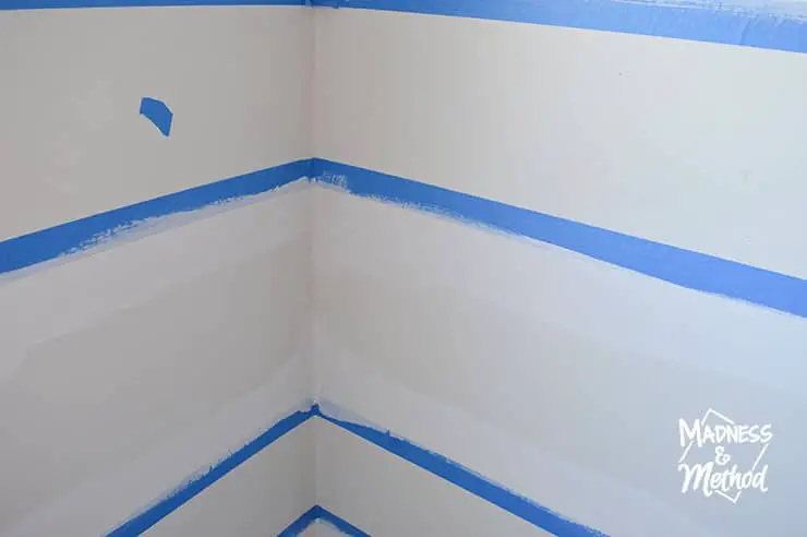 painting base coat on blue painters tape white walls