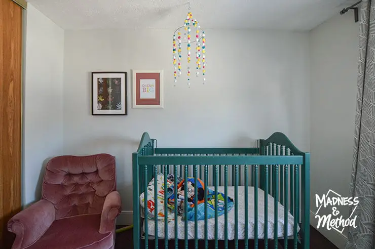 green crib and pompom mobile