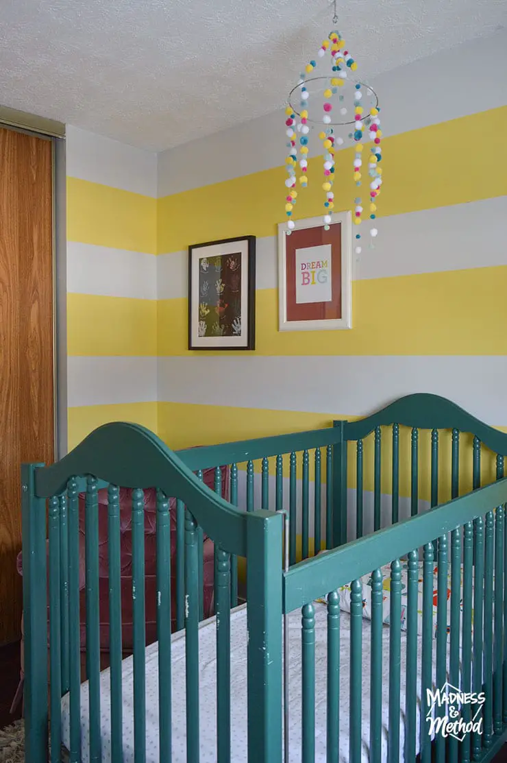 green crib and yellow white stripe walls