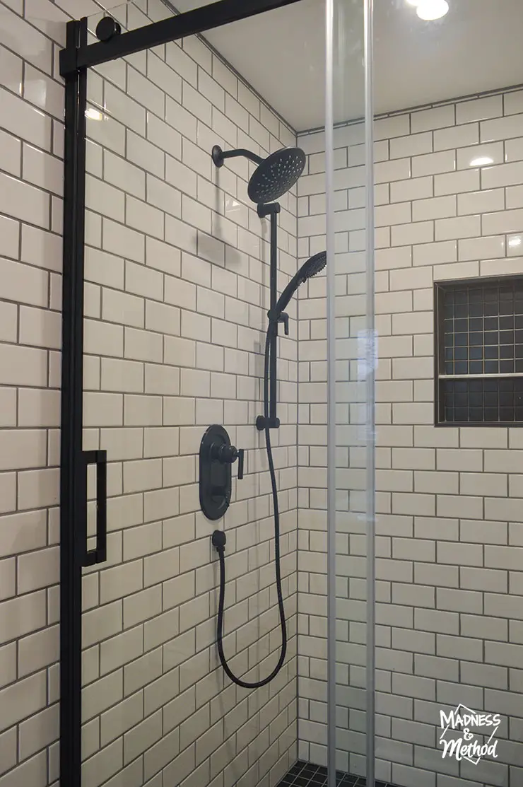 white subway tile black fixtures in shower