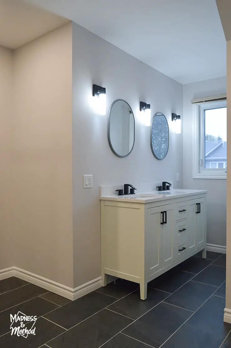 white vanity with oval mirrors