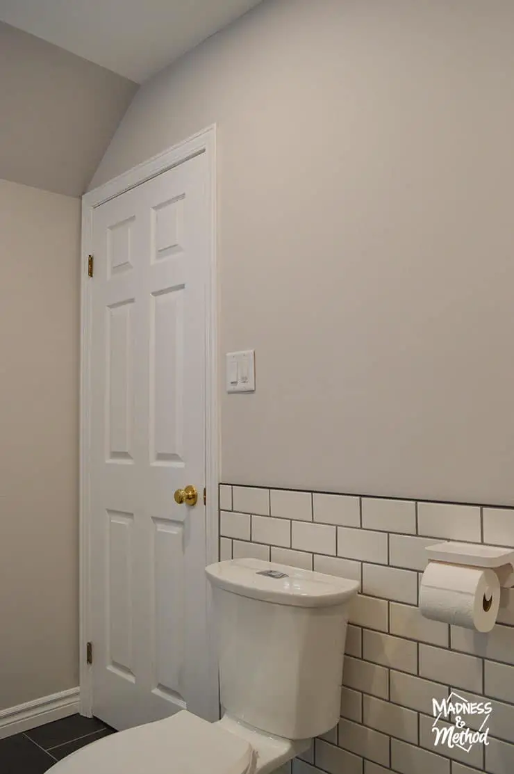 white subway tile behind toilet