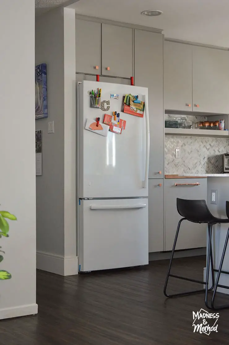 white fridge gray kitchen dark floors