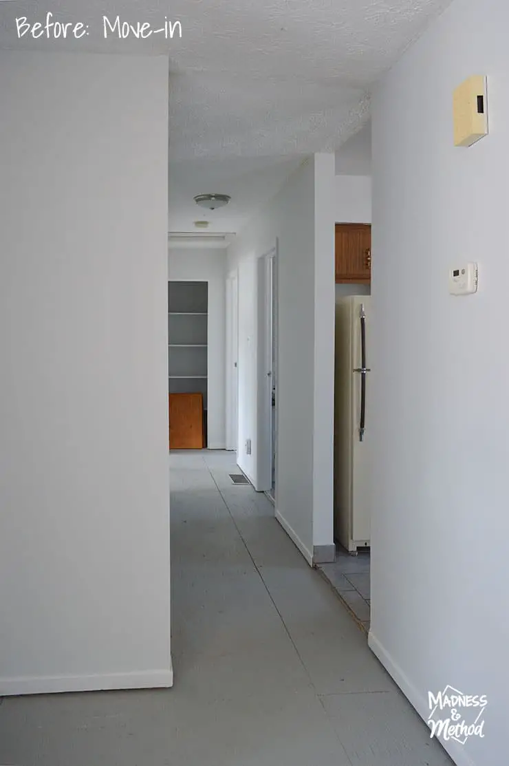 raised ranch hallway with white walls and gray floors