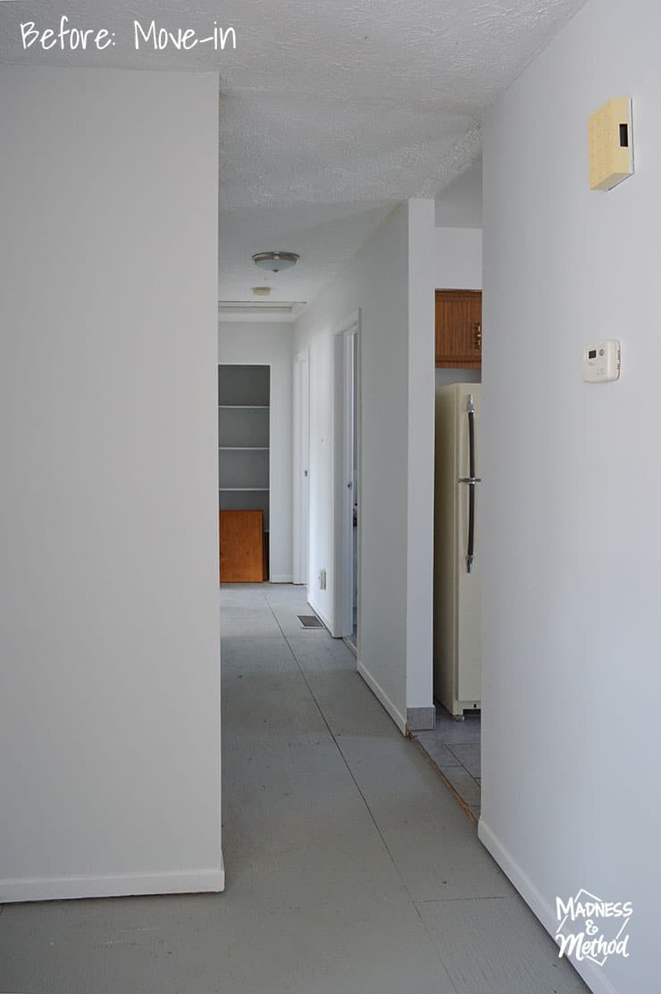 raised ranch hallway with white walls and gray floors