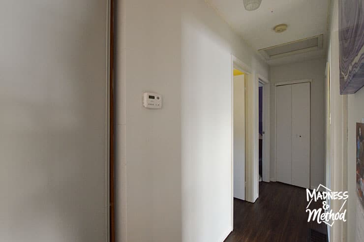 bland hallway with white walls and dark floors