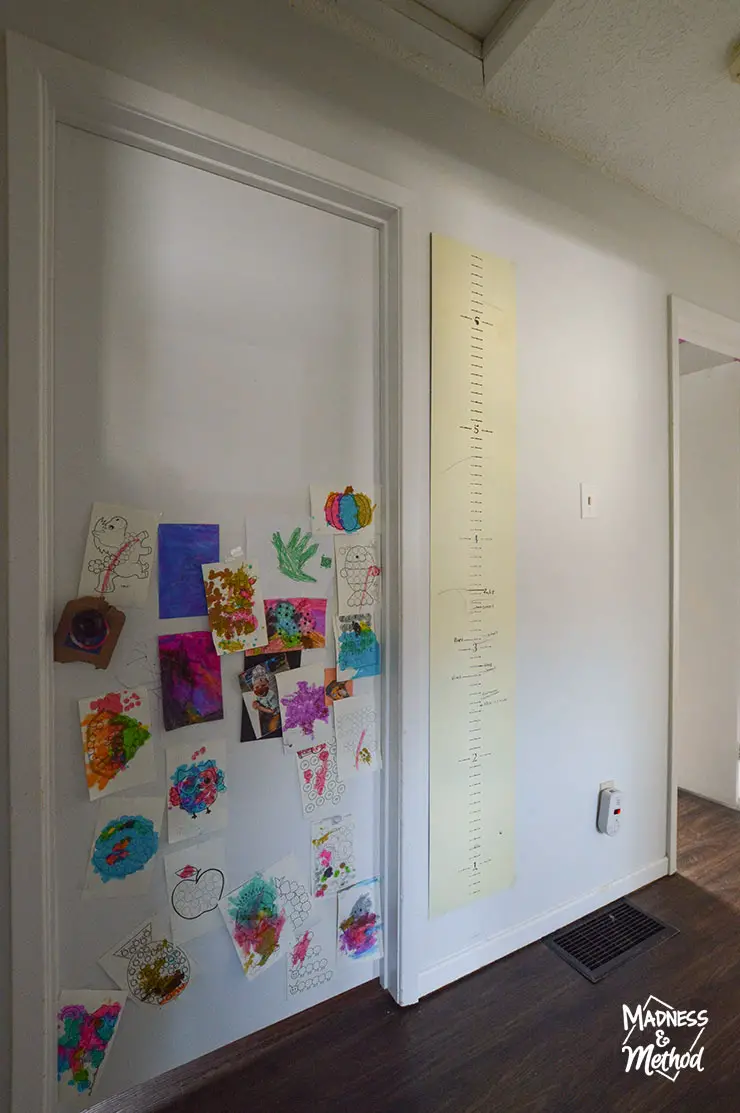 white hallway walls and white doors with kid drawings