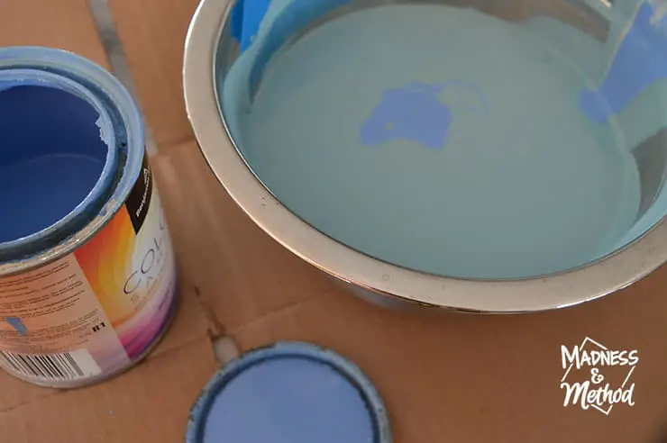 mixing blue paint in metal bowl