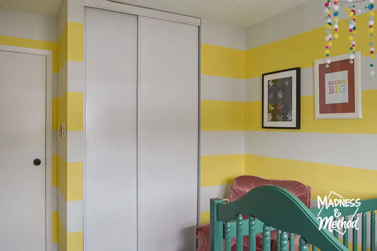 white sliding closet doors in yellow nursery