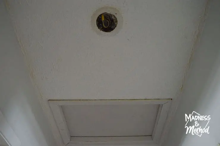 white ceiling with hole and attic access