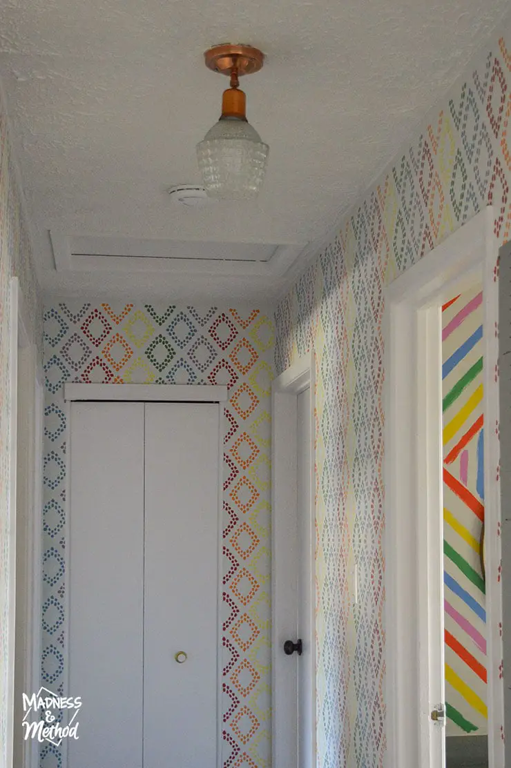 rainbow accent wall in hallway with white ceiling
