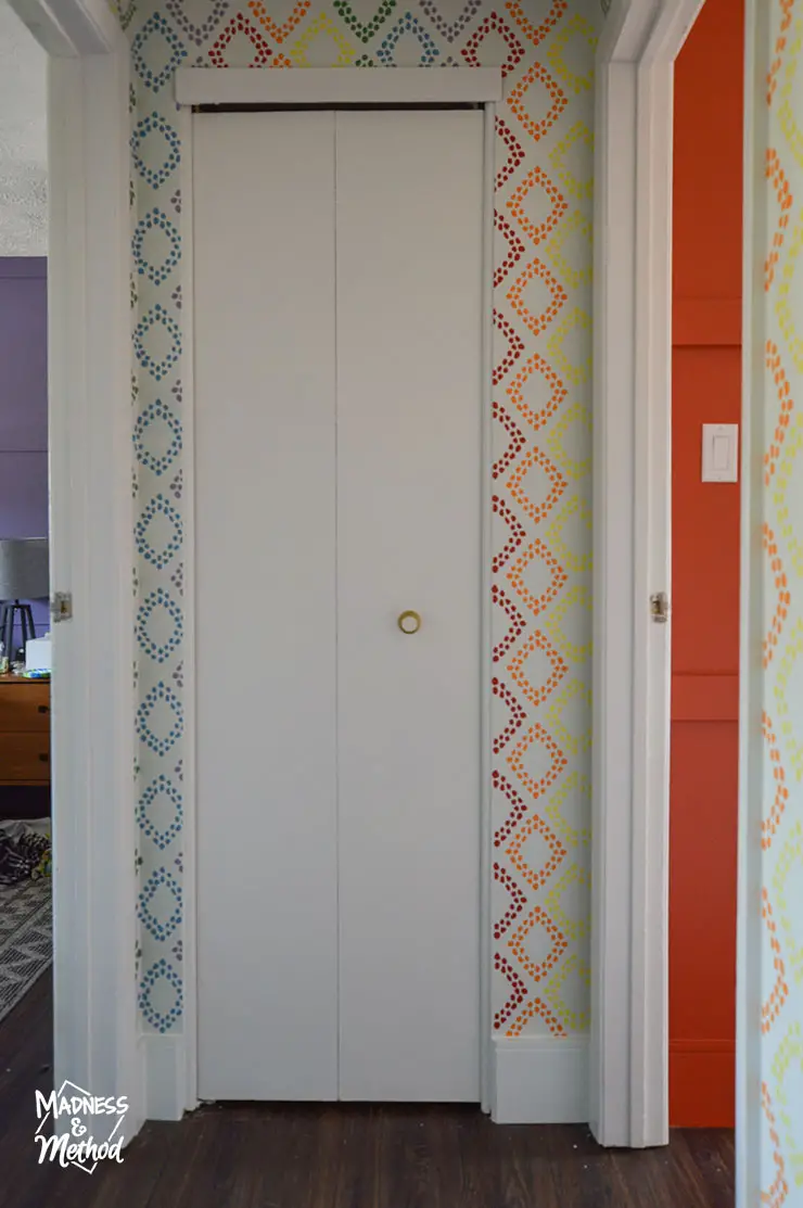 white bifold door near rainbow walls