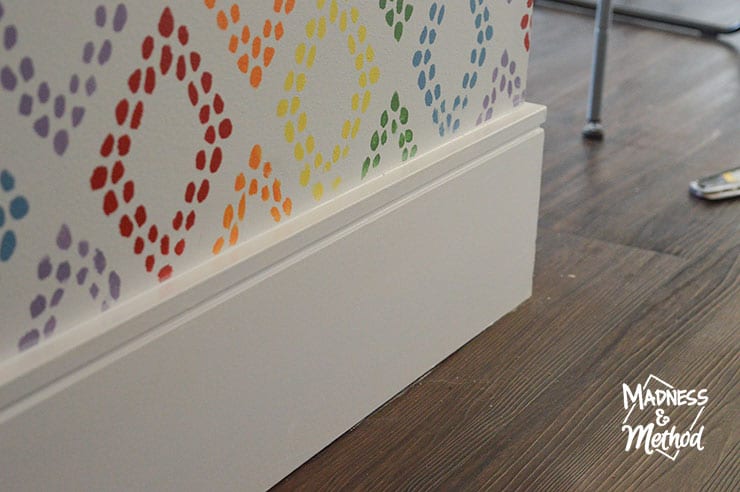 white baseboards and rainbow walls