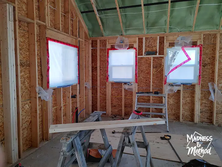 interior kitchen framing with three windows