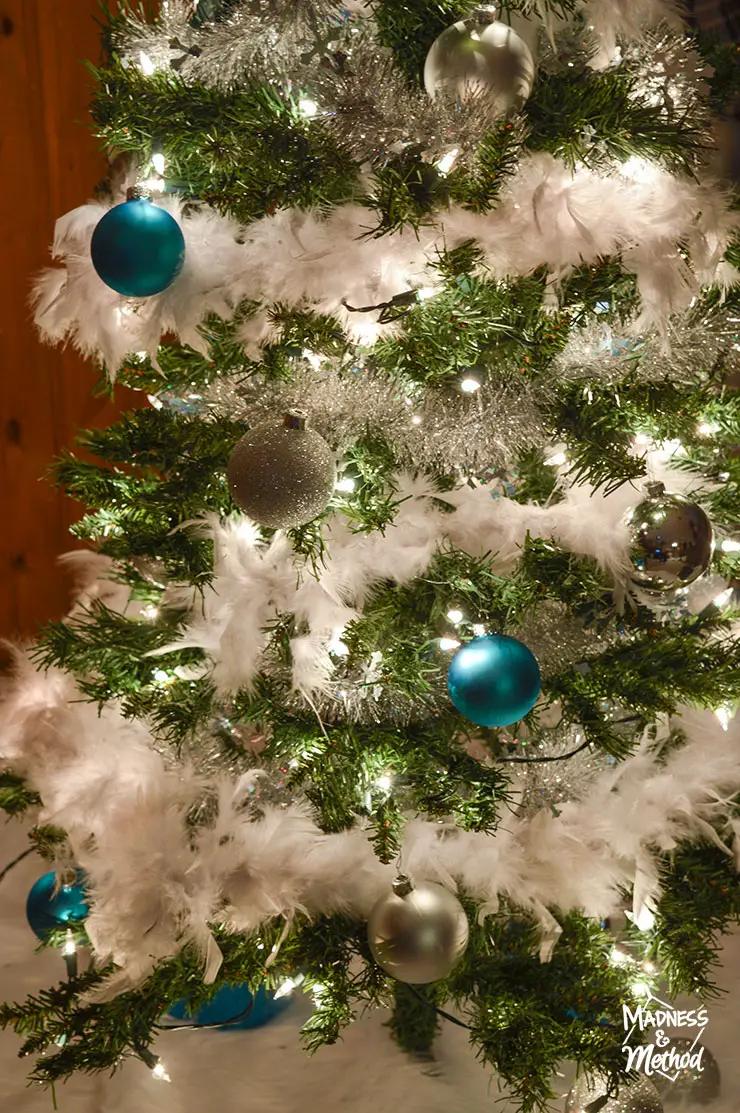 blue and silver christmas tree with white boas
