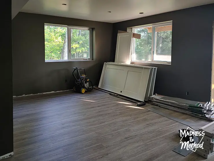 big windows in basement with dark walls