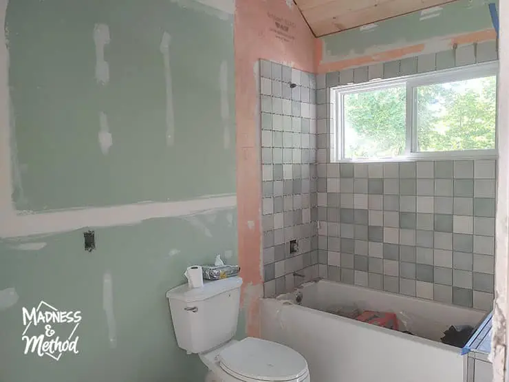 green drywall in bathroom with tiles