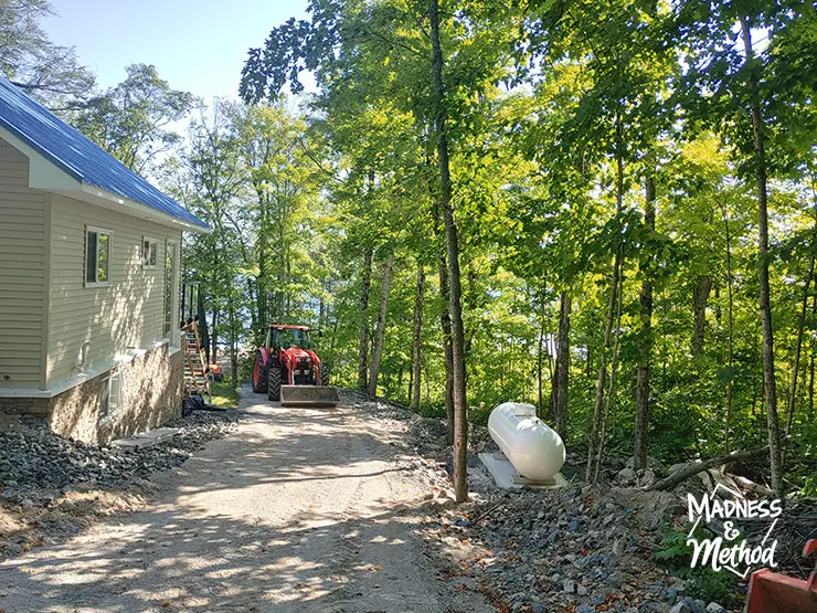 cottage driveway with propane tank and tractor