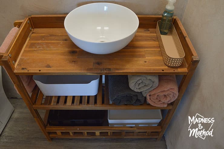 white vessel sink open shelves