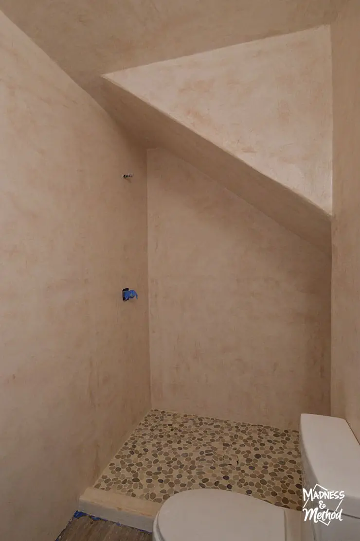 microcement shower with angled ceiling