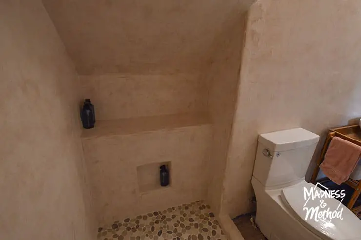 pink microcement bathroom with tile floor