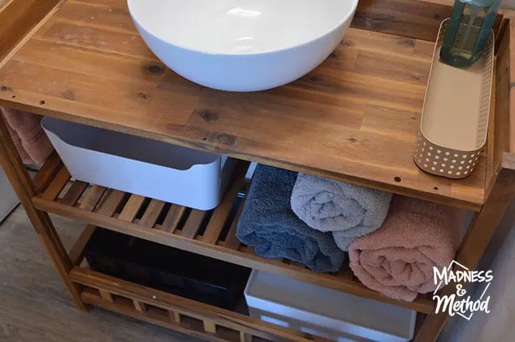 open vanity with bins and towels