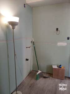 view to vanity with green drywall