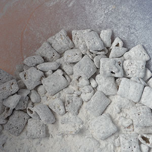 puppy chow in bowl with icing sugar