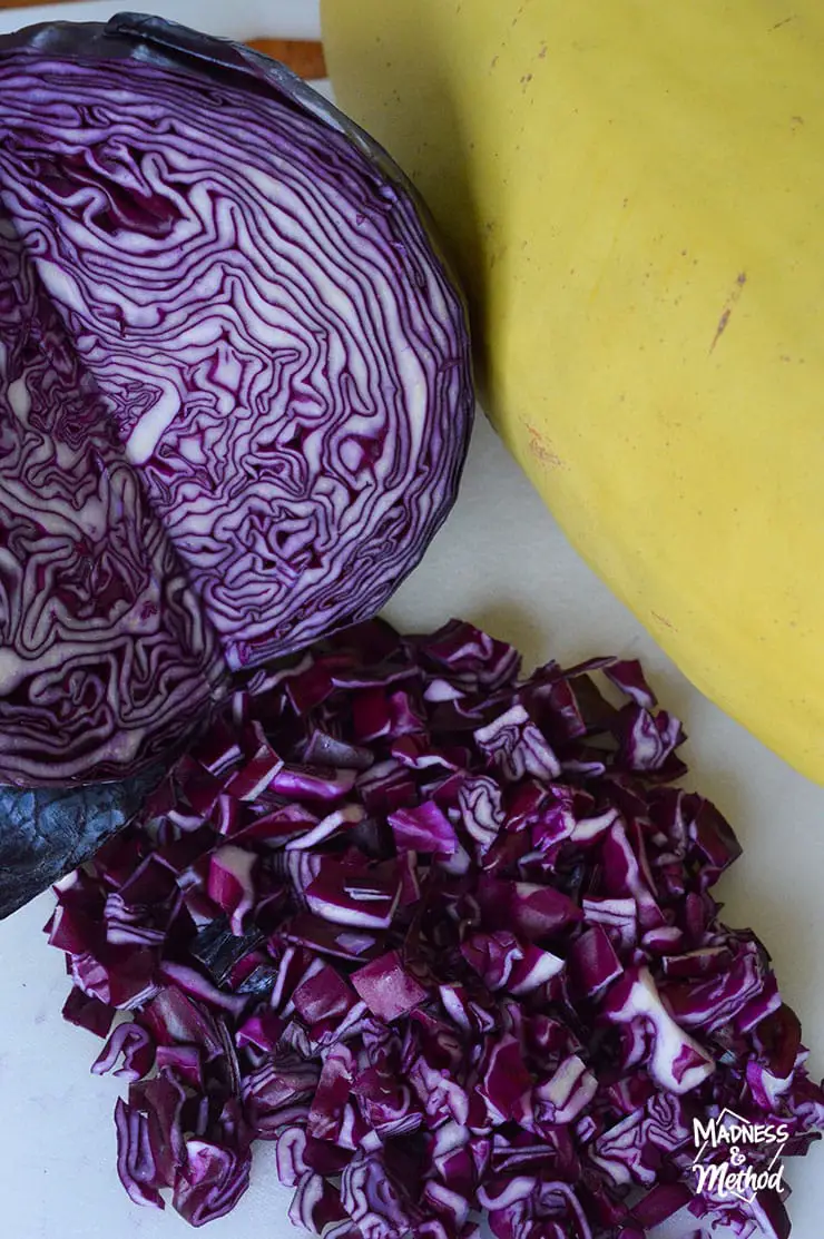 chopped purple cabbage next to spaghetti squash