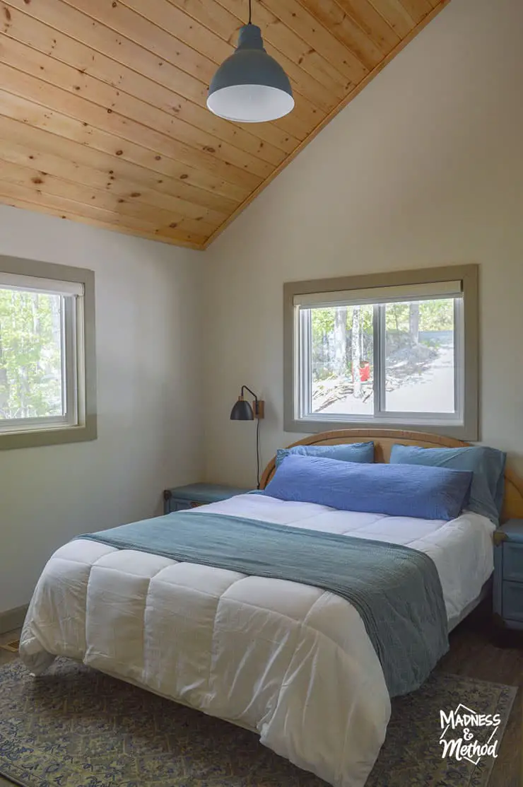 light bedroom with wood ceiling