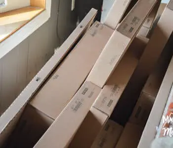 ikea boxes lined up behind sofa
