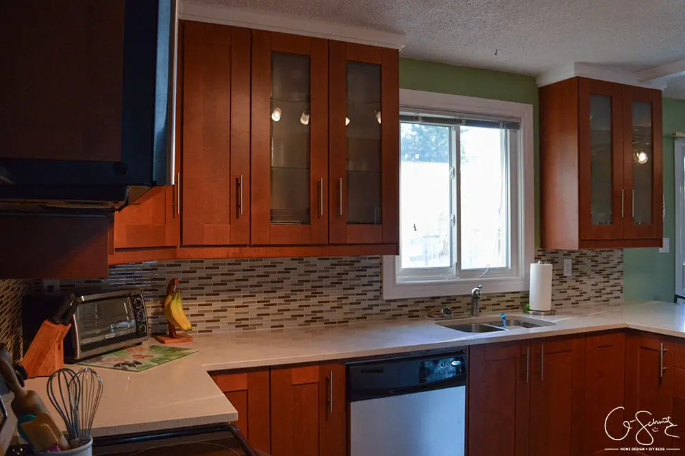 The before and after photo reveal of our DIY kitchen renovation. Check out all the great features we added to make this space unique. I can’t believe what it used to look like!