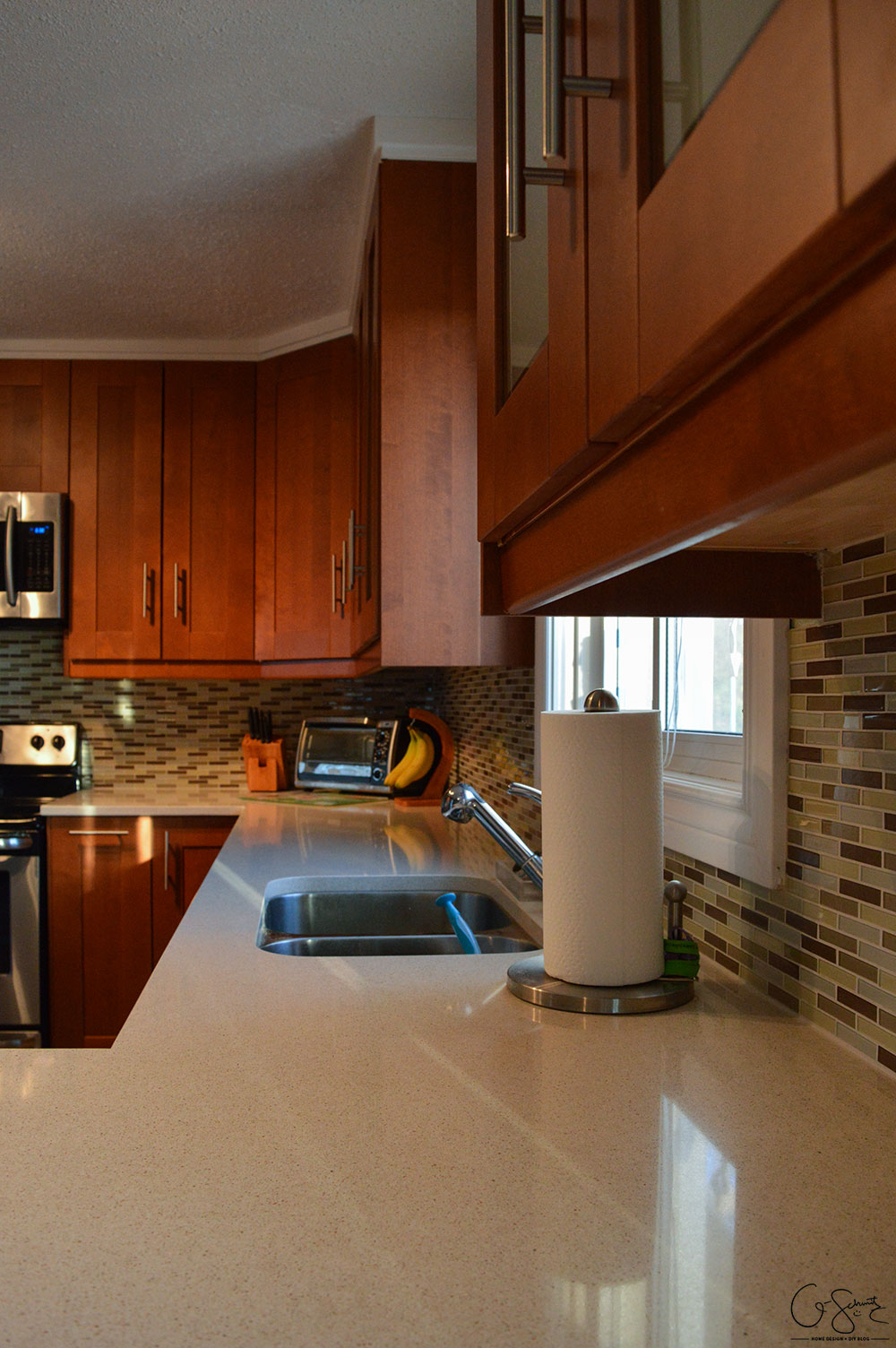 The before and after photo reveal of our DIY kitchen renovation. Check out all the great features we added to make this space unique. I can’t believe what it used to look like!