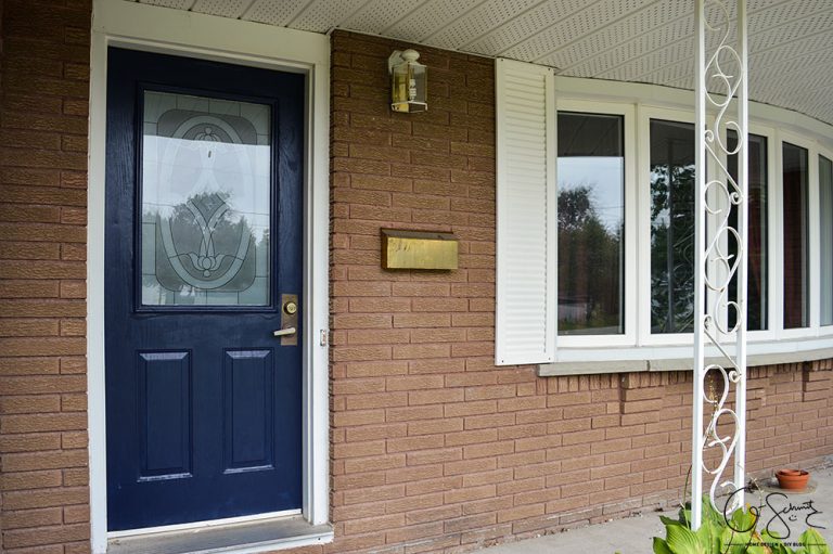 Navy blue front door on red brick house Madness & Method