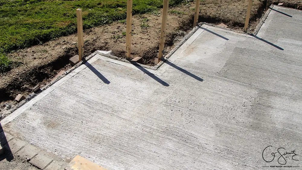 Our project walkway is almost complete now that the DIY concrete is set. Check out the pictures of how it looks currently and read my pros and cons of going with a DIY walkway versus professional concrete.