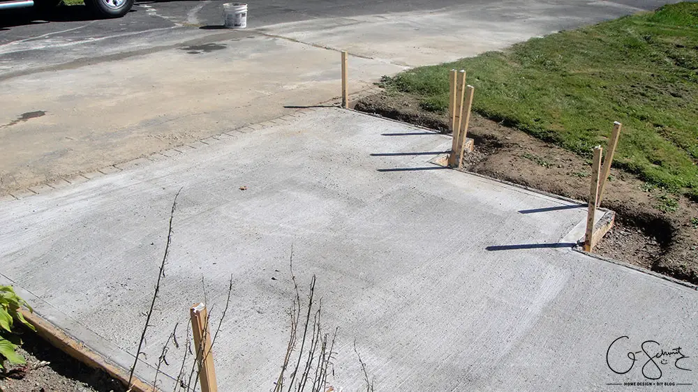 Our project walkway is almost complete now that the DIY concrete is set. Check out the pictures of how it looks currently and read my pros and cons of going with a DIY walkway versus professional concrete.
